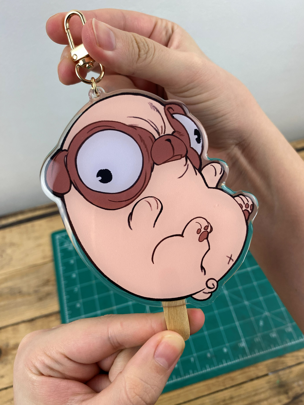 Pug-shaped Keychain that looks like a bean-shaped popsicle.