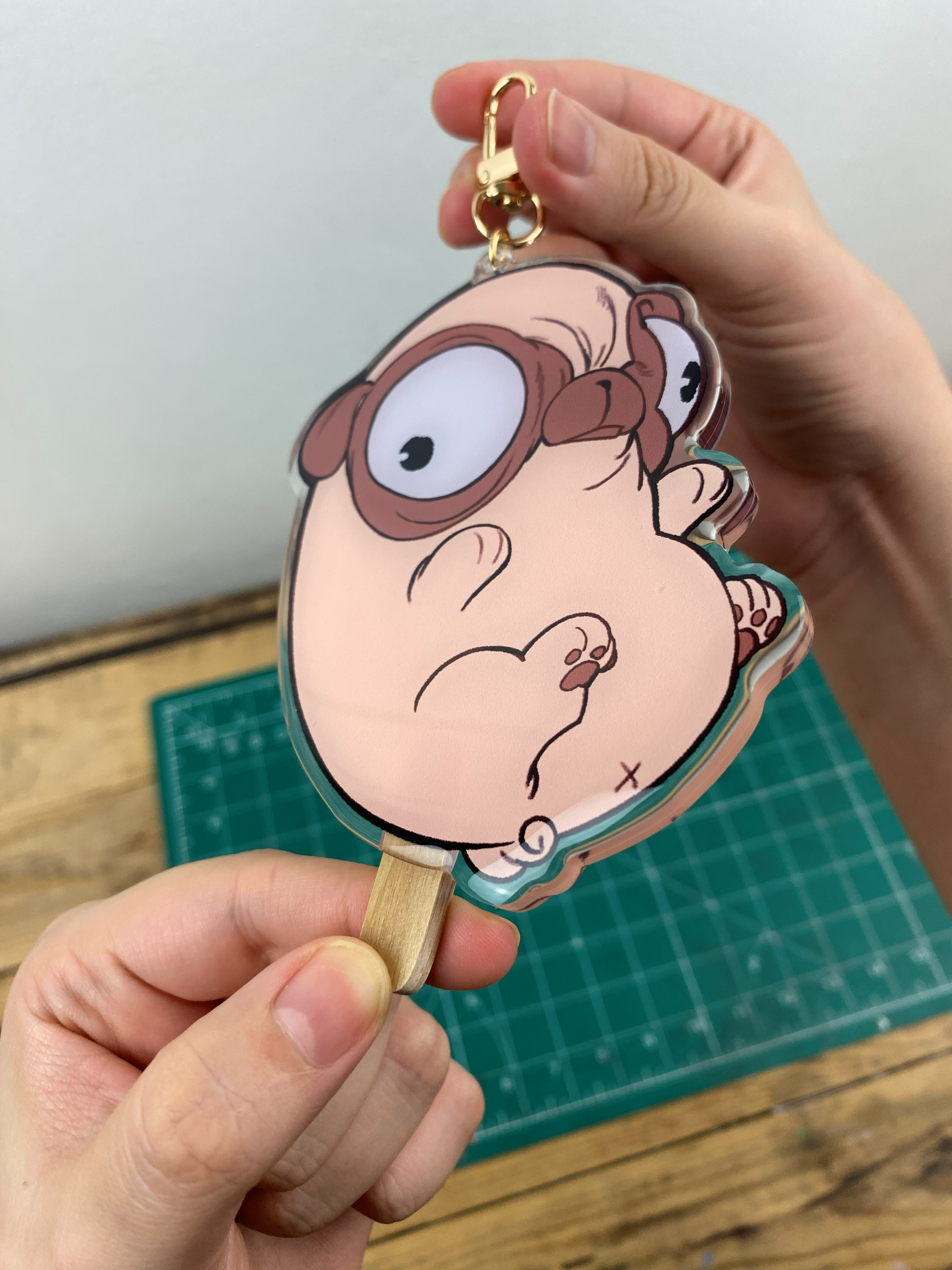 Pug-shaped Keychain that looks like a bean-shaped popsicle.