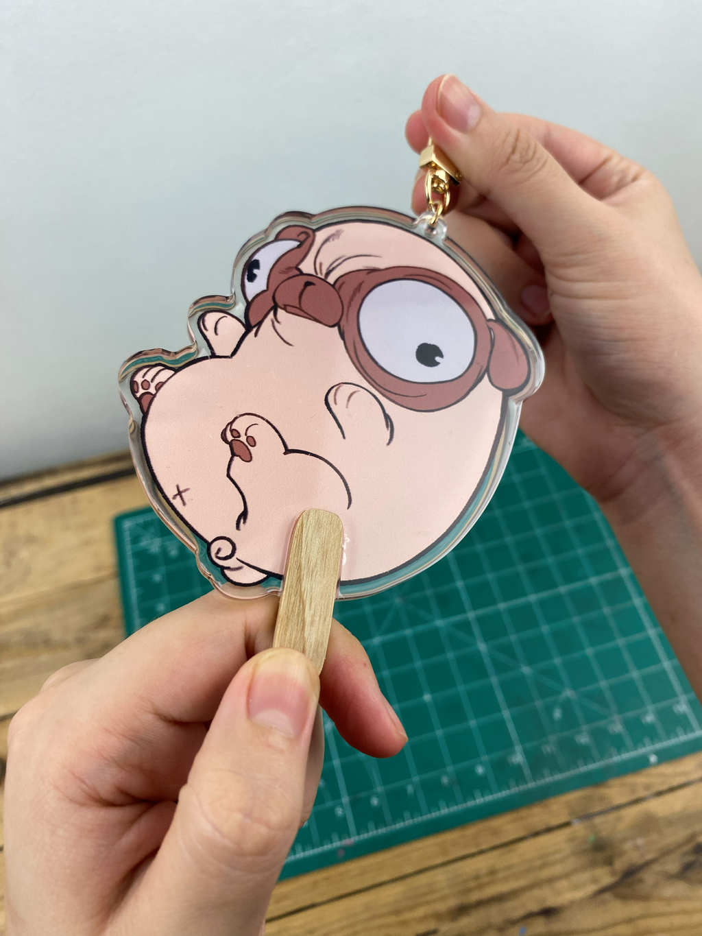 Pug-shaped Keychain that looks like a bean-shaped popsicle.
